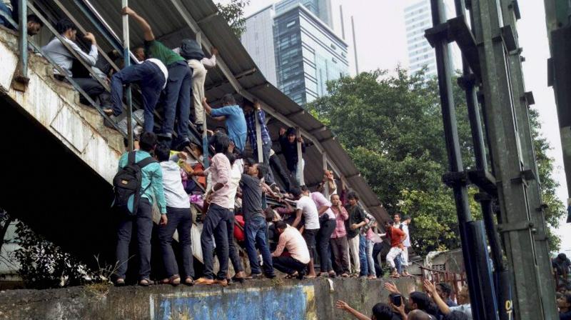 A rumour about the overbridge 'collapsing' sparked panic among morning peak-hour commuters on a rainy day, leading to people rushing towards its staircase with several of them slipping on the wet steps and falling over one another. (Photo: PTI | File) A rumour about the overbridge 'collapsing' sparked panic among morning peak-hour commuters on a rainy day, leading to people rushing towards its staircase with several of them slipping on the wet steps and falling over one another. (Photo: PTI | File)