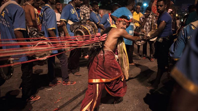 Devotees pierced their faces with tridents or hung multiple hooks and chains from their bodies in an act of penance. (Photo: AFP) Devotees pierced their faces with tridents or hung multiple hooks and chains from their bodies in an act of penance. (Photo: AFP)