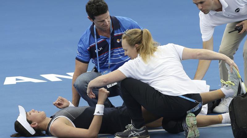 Garbine Muguruza, who held the No. 1 ranking for four weeks last year, lasted three games in the third before being stopped by the cramps after almost 2 hours in humid conditions. (Photo:AP) Garbine Muguruza, who held the No. 1 ranking for four weeks last year, lasted three games in the third before being stopped by the cramps after almost 2 hours in humid conditions. (Photo:AP)