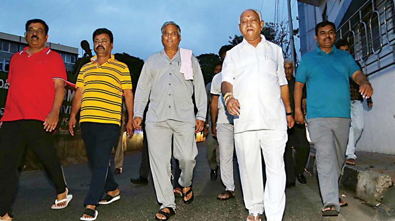 Opposition leader B.S. Yeddyurappa , V. Somanna and others take a morning walk after overnight dharna in the Vidhana Soudha on Friday. (KPN) Opposition leader B.S. Yeddyurappa , V. Somanna and others take a morning walk after overnight dharna in the Vidhana Soudha on Friday. (KPN)