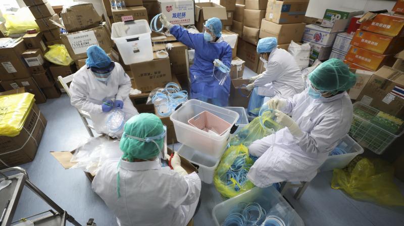 Nurses assemble plastic face shields at a hospital designated for the coronavirus patients in Wuhan. AFP Photo