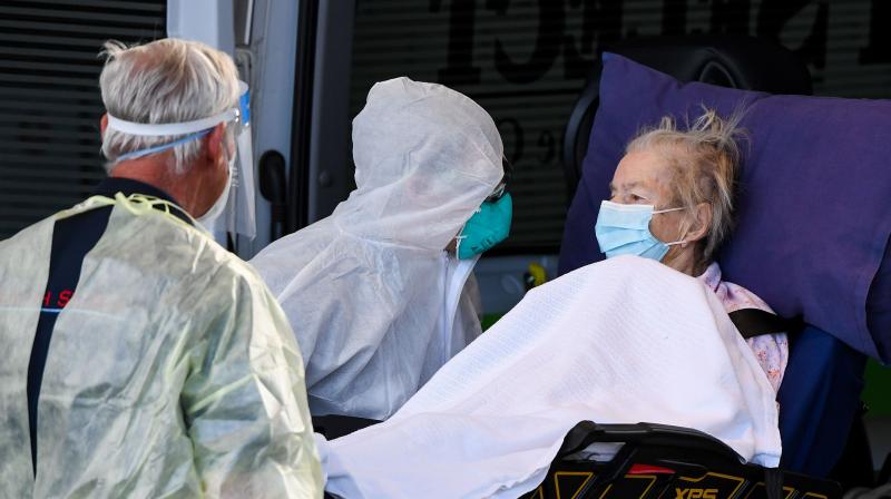 Medical workers evacuate a resident from the Epping Gardens aged care facility in the Melbourne suburb of Epping on July 30, 2020, as the city battles fresh outbreaks of the COVID-19 coronavirus. (AFP)