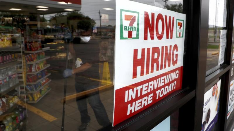 A sign on the window at a 7-Eleven store reads, "Now Hiring," as an employee inside the store wears a mask and gloves while mopping the floor amid the coronavirus health crisis in Dallas, Wednesday, April 22, 2020. (AP Photo) A sign on the window at a 7-Eleven store reads, "Now Hiring," as an employee inside the store wears a mask and gloves while mopping the floor amid the coronavirus health crisis in Dallas, Wednesday, April 22, 2020. (AP Photo)