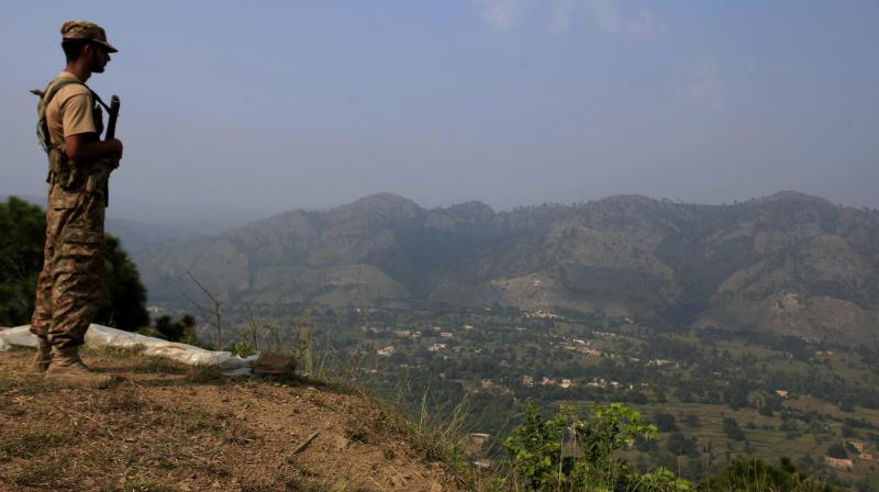 Pakistan army soldier monitors the area from a forward area Bagsar post on the Line of Control (LOC), that divides Kashmir between Pakistan and India, in Bhimber. (Photo: PTI) Pakistan army soldier monitors the area from a forward area Bagsar post on the Line of Control (LOC), that divides Kashmir between Pakistan and India, in Bhimber. (Photo: PTI)