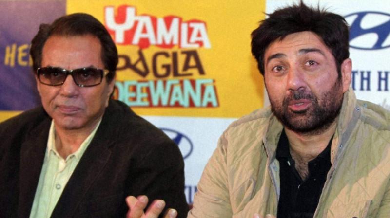 Dharmendra with son Sunny Deol at the event. (File Photo) Dharmendra with son Sunny Deol at the event. (File Photo)