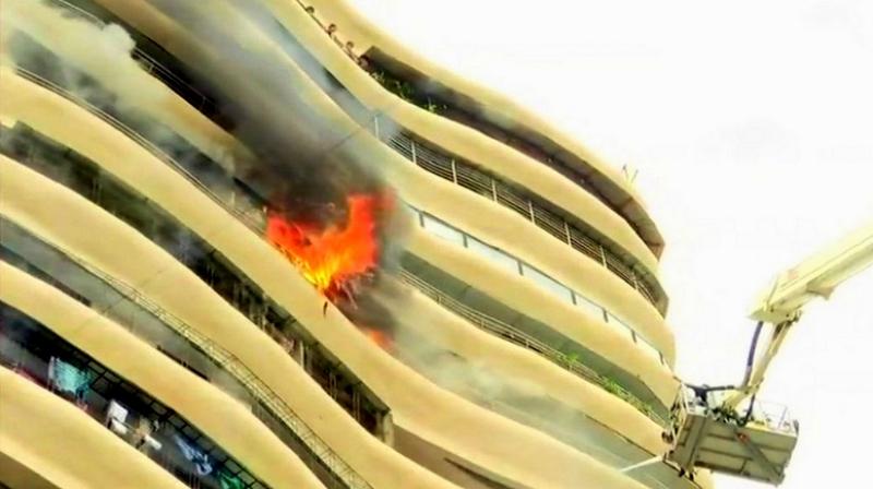 People trapped in the building are being rescued using a crane. (Photo: ANI | Twitter) People trapped in the building are being rescued using a crane. (Photo: ANI | Twitter)