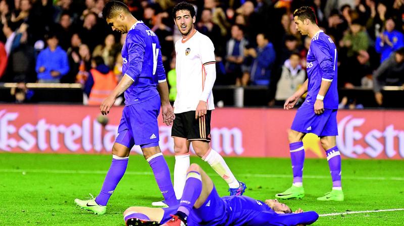 Real Madrid’s Casemiro (left), Gareth Bale (on the ground) and Cristiano Ronaldo (right) react after their 1-2 defeat to Valencia in their La Liga match at the Mestalla Stadium in Valencia on Wednesday. (Photo: AFP) Real Madrid’s Casemiro (left), Gareth Bale (on the ground) and Cristiano Ronaldo (right) react after their 1-2 defeat to Valencia in their La Liga match at the Mestalla Stadium in Valencia on Wednesday. (Photo: AFP)