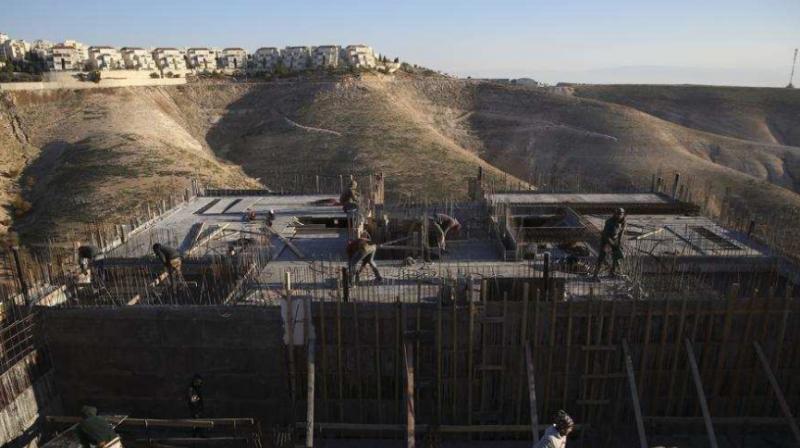 Palestinian laborers work at a construction site in the Israeli settlement of Maale Adumim, near Jerusalem. (Photo: AP) Palestinian laborers work at a construction site in the Israeli settlement of Maale Adumim, near Jerusalem. (Photo: AP)