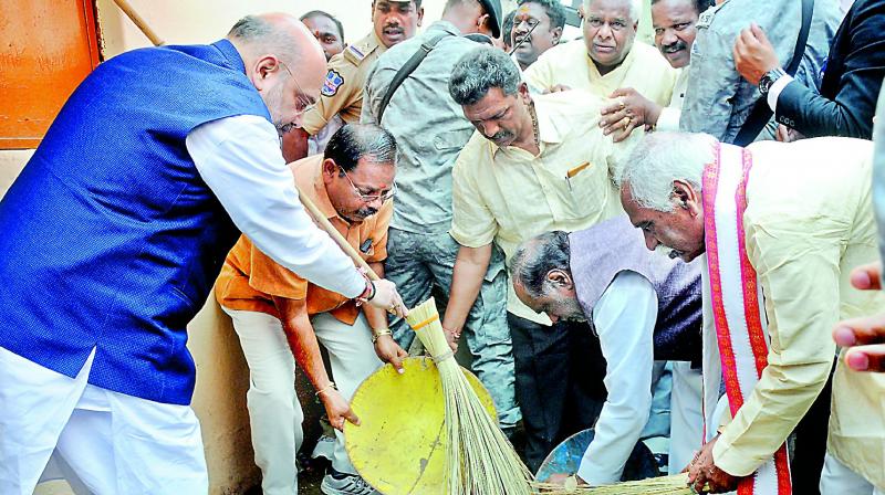 BJP national president Amit Shah along with BJP state president K. Laxman and former minister Bandaru Dattareya take part in Swachta Hi Seva, a nation-wide programme, at Bheema Maidan, NTR Stadium, on Saturday. (Photo: Deepak Deshpande) BJP national president Amit Shah along with BJP state president K. Laxman and former minister Bandaru Dattareya take part in Swachta Hi Seva, a nation-wide programme, at Bheema Maidan, NTR Stadium, on Saturday. (Photo: Deepak Deshpande)