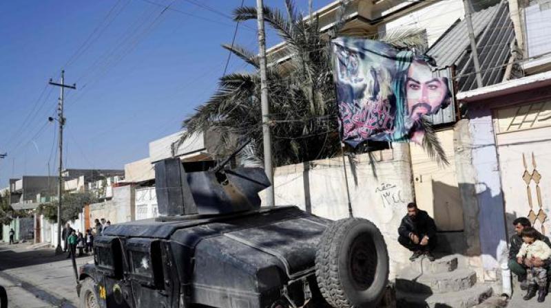 A flag bearing a portrait of Prophet Mohammed's grandson, Imam Hussein, flutters above an Iraqi Special Forces vehicle patrolling a northeastern district of the city of Mosul. (Photo: AFP) A flag bearing a portrait of Prophet Mohammed's grandson, Imam Hussein, flutters above an Iraqi Special Forces vehicle patrolling a northeastern district of the city of Mosul. (Photo: AFP)