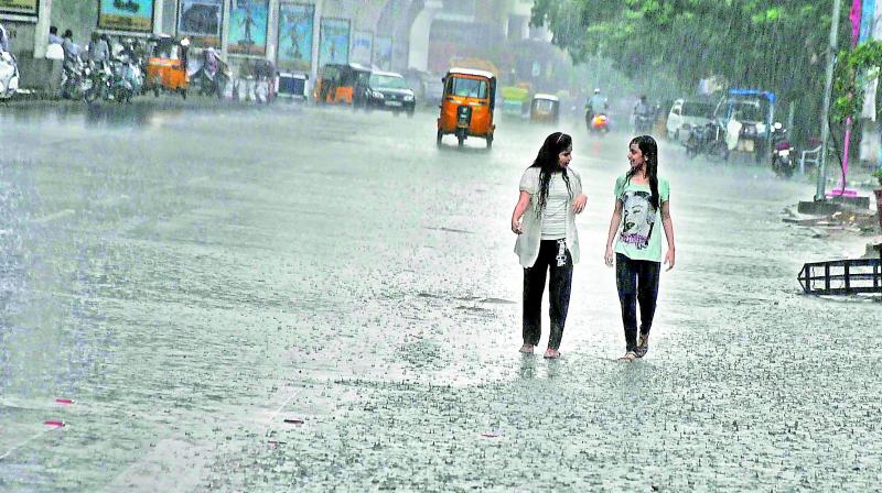 Students walk in the rain at Nampally in Hyderabad. (Photo: DC) Students walk in the rain at Nampally in Hyderabad. (Photo: DC)