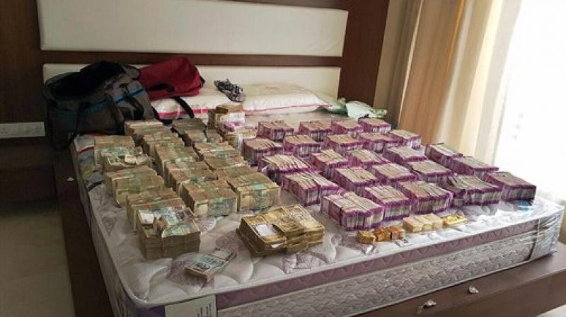 Rs 4.7 crore cash in new currency seized by Income Tax department in Bengaluru along with Rs 100 and demonetised Rs 500 notes. Rs 4.7 crore cash in new currency seized by Income Tax department in Bengaluru along with Rs 100 and demonetised Rs 500 notes.