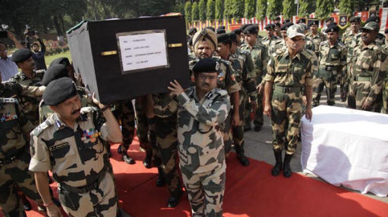 BSF officers carry the coffin of head constable Jitender Kumar Singh, during a wreath-laying ceremony at BSF headquarters in Jammu. (Photo: AP) BSF officers carry the coffin of head constable Jitender Kumar Singh, during a wreath-laying ceremony at BSF headquarters in Jammu. (Photo: AP)