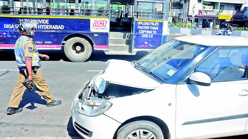 Police inspects a car that rammed into an RTC bus at Tarnaka on Friday. (Photo: DC) Police inspects a car that rammed into an RTC bus at Tarnaka on Friday. (Photo: DC)