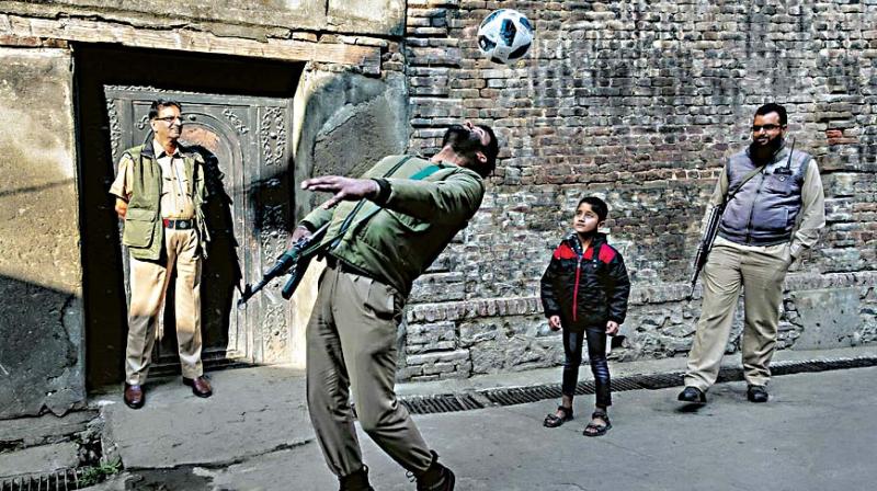 A photograph of armymen playing with children on display at ‘Real Kashmir’ photo exhibition A photograph of armymen playing with children on display at ‘Real Kashmir’ photo exhibition