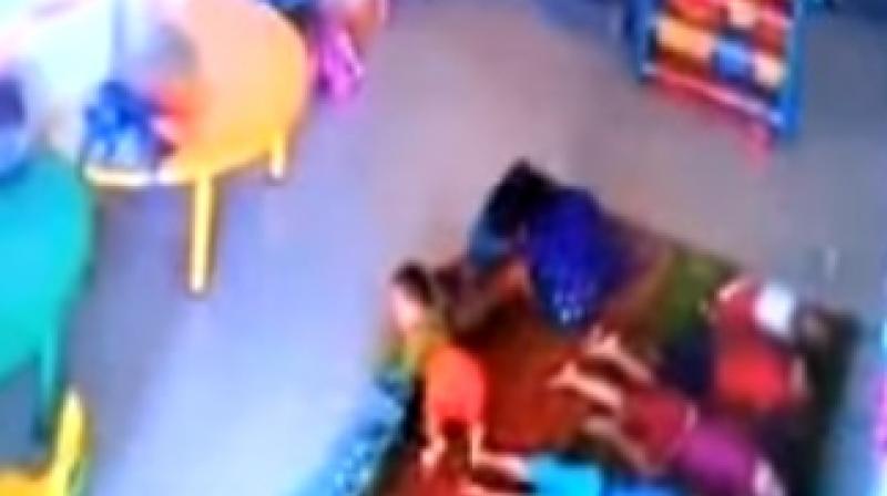 Caretaker assaulting a 10-month-old girl in a crèche (Photo: video grab) Caretaker assaulting a 10-month-old girl in a crèche (Photo: video grab)