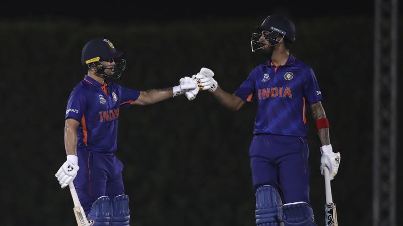 Indias KL Rahul (right) and Ishan Kishan celebrate scoring runs during the Cricket Twenty20 World Cup warm-up match between India and England in Dubai on Monday. (Photo: AP)