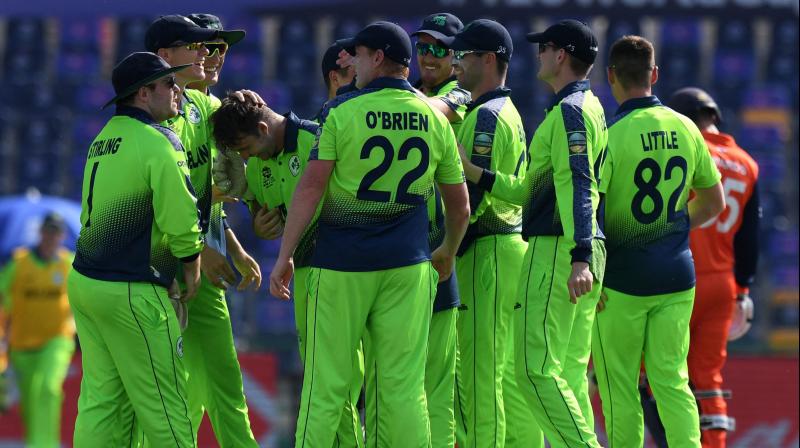 Irelands Curtis Campher (4L) celebrates with teammates after taking the wicket of Netherlands Roelof van der Merwe (not pictured) during the ICC mens Twenty20 World Cup cricket match between Ireland and Netherlands at the Sheikh Zayed Stadium in Abu Dhabi on Monday. (Photo: AFP)