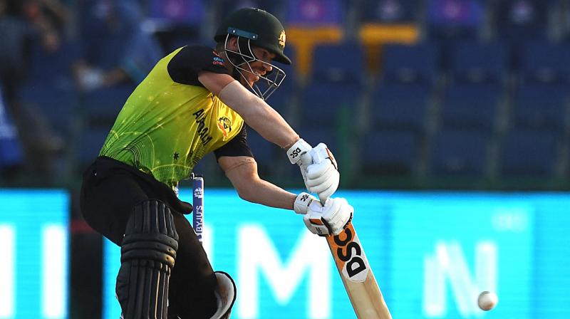 Australias David Warner plays a shot during the ICC mens Twenty20 World Cup cricket match between Australia and West Indies at the Sheikh Zayed Cricket Stadium in Abu Dhabi on Saturday. (Photo: AFP)