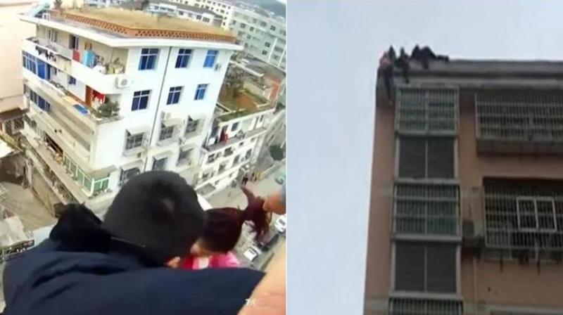 The man held on to his wife for more than three minutes, trying to convince her to come back to safety until the police arrived and rescued her. (Photo: Facebook) The man held on to his wife for more than three minutes, trying to convince her to come back to safety until the police arrived and rescued her. (Photo: Facebook)