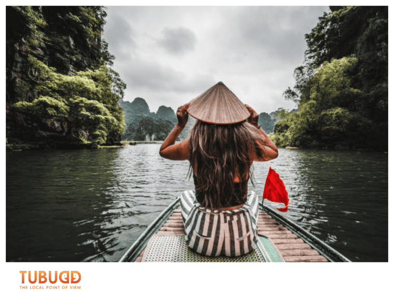 Sail through emerald waters and limestone karsts on a boat.