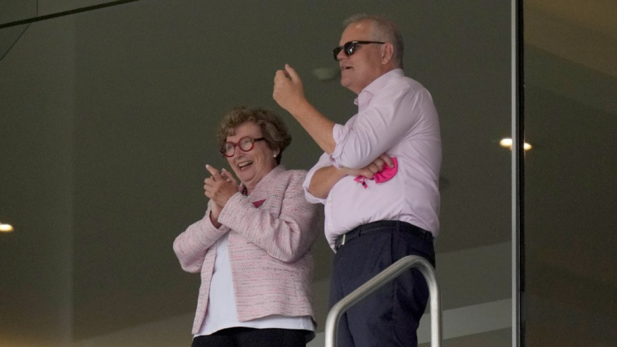 Australia's Prime Minister Scott Morrison (R) at the stands during a cricket match. Australia's Prime Minister Scott Morrison