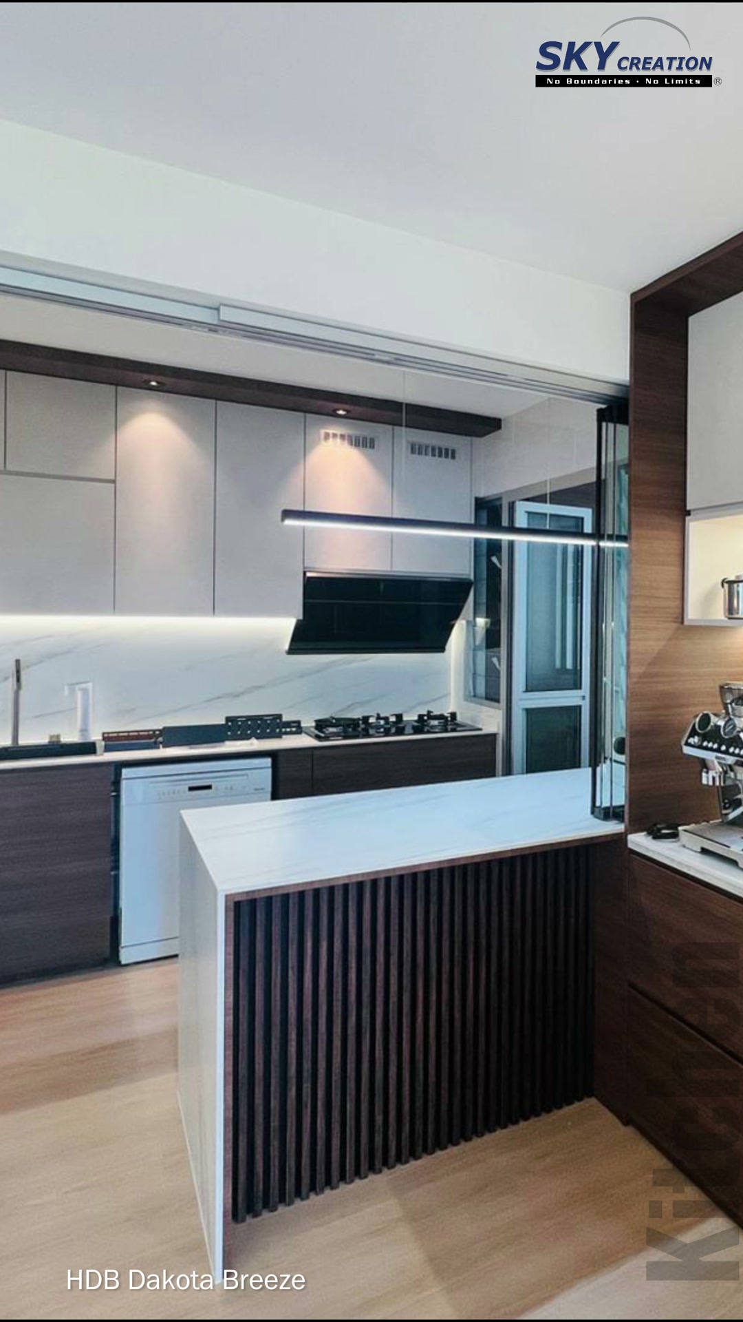 Dakota Breeze coffee counter beside a black-framed serving opening to the kitchen