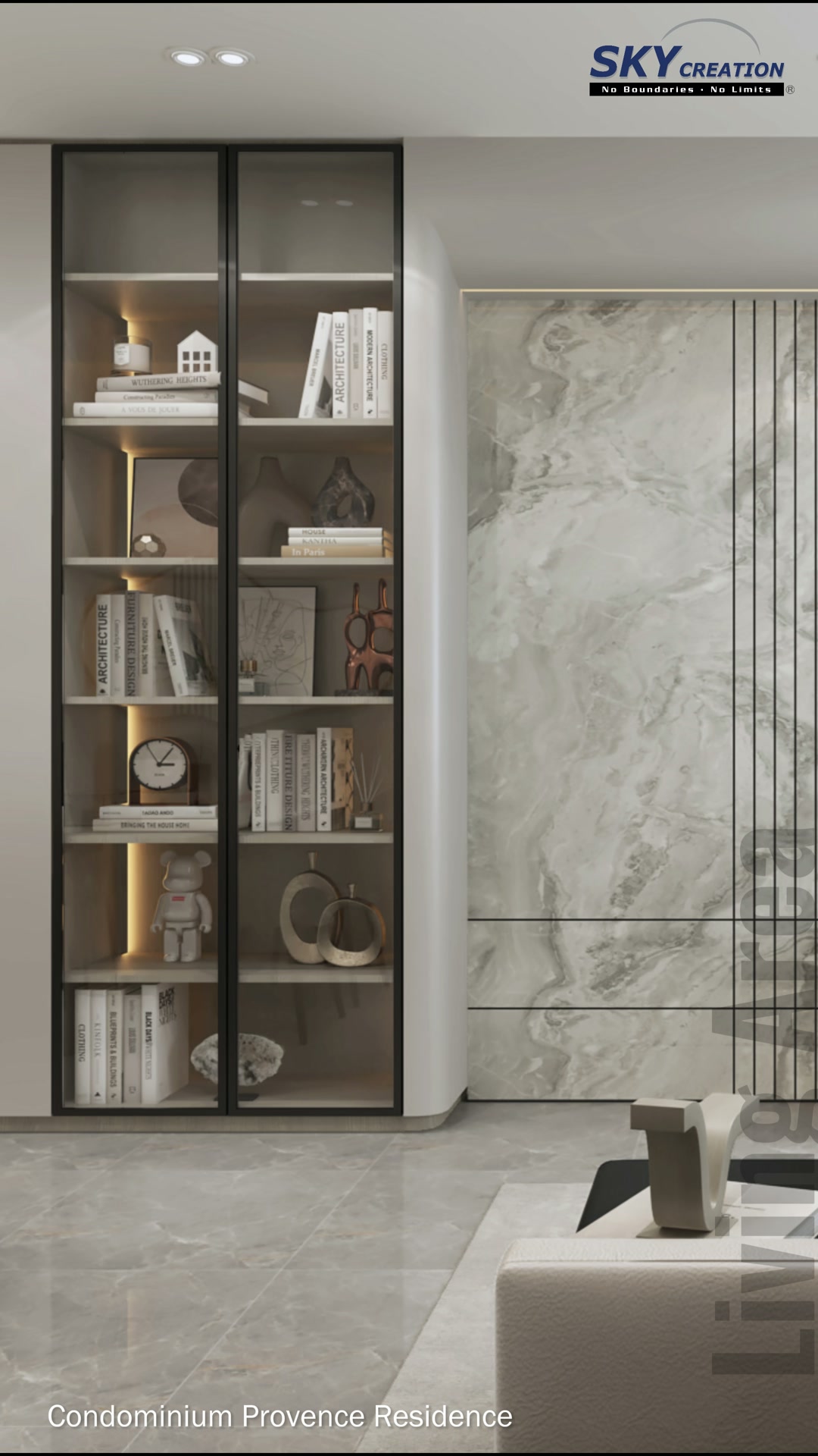 Provence Residences living room with a marble-look television wall and black-framed display cabinet