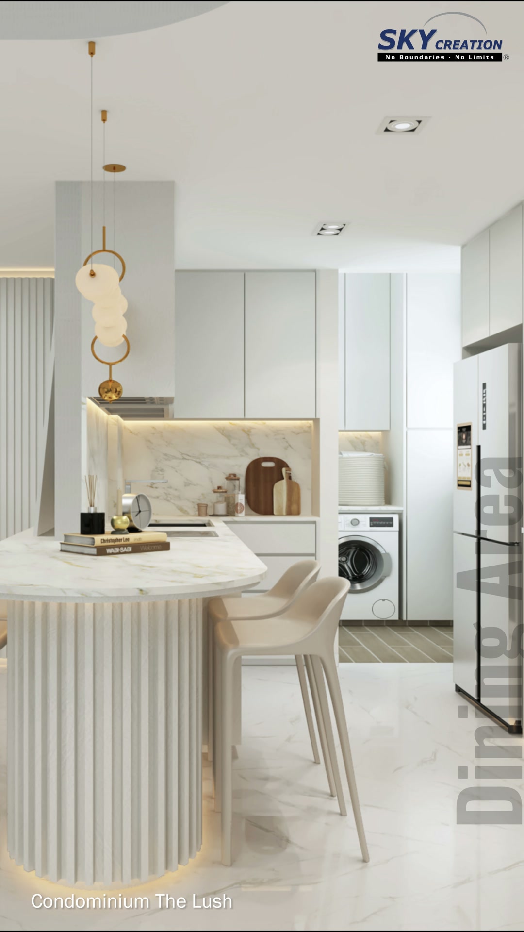 The Lush dining area with rounded pedestal table, pendant light and pale kitchen cabinetry