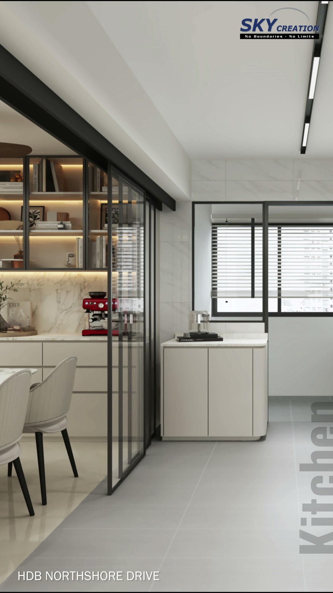 Northshore Drive dining and kitchen threshold with black-framed glass divider, pale chairs and illuminated display cabinetry