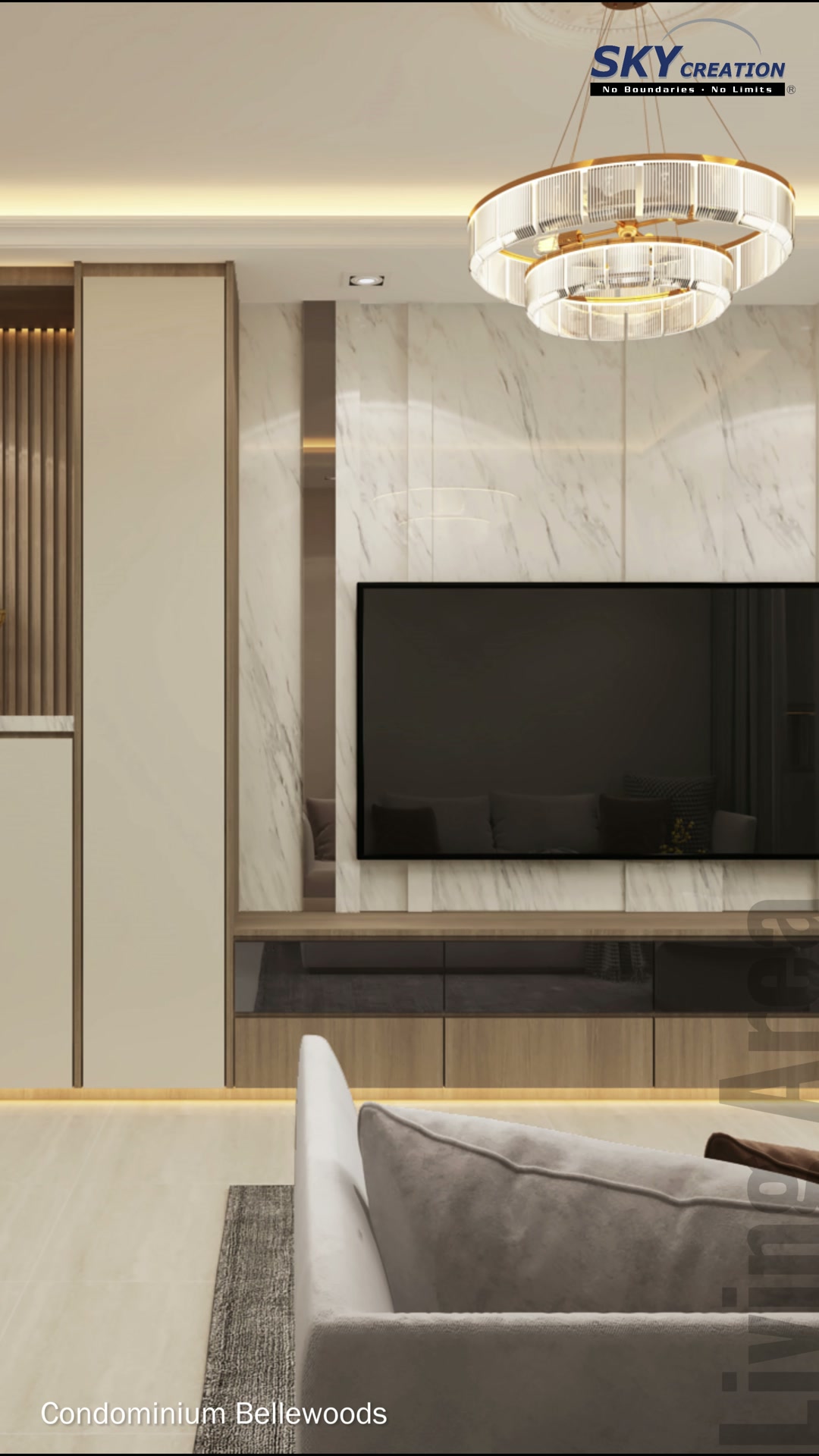 Bellewoods living area with a marble-look television wall, warm display lighting, a circular pendant and pale seating