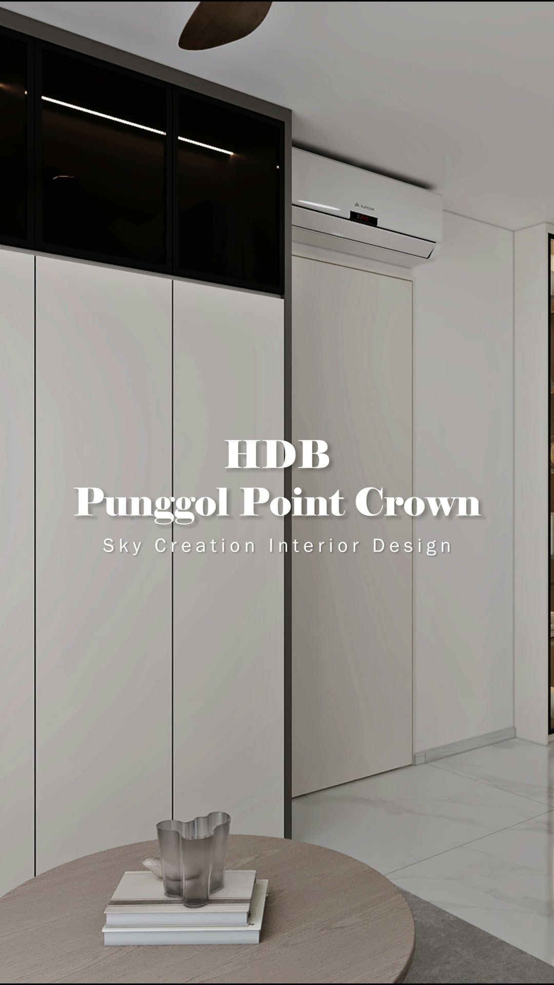 Punggol Point Crown living area with full-height white storage and a dark-glass upper band