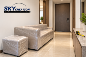 Design illustration of wrapped furniture beside a condo entrance and a measuring tape