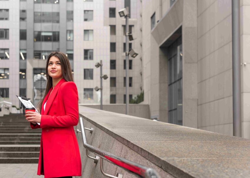 brunette businesswoman outdoors with read coat1