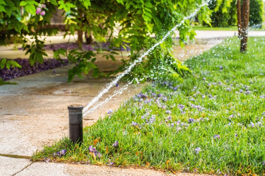 automatic sprinklers watering grass lawn scaled 1