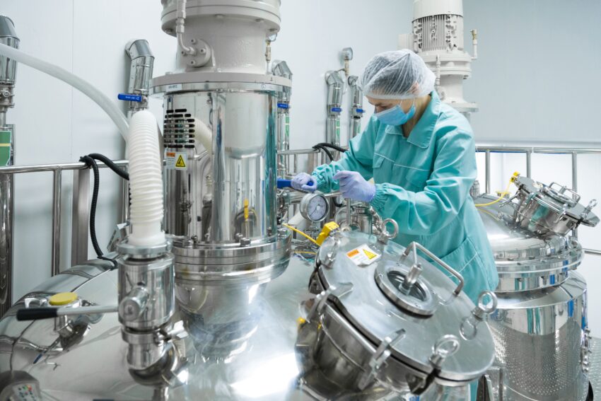 pharmaceutical factory woman worker protective clothing operating production line sterile environment 1