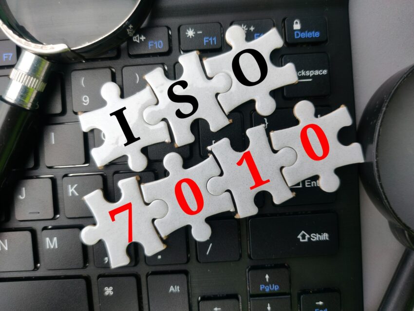 top view puzzle and magnifying glass with the word iso 7010