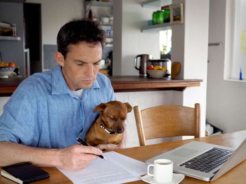 person paperwork with dog