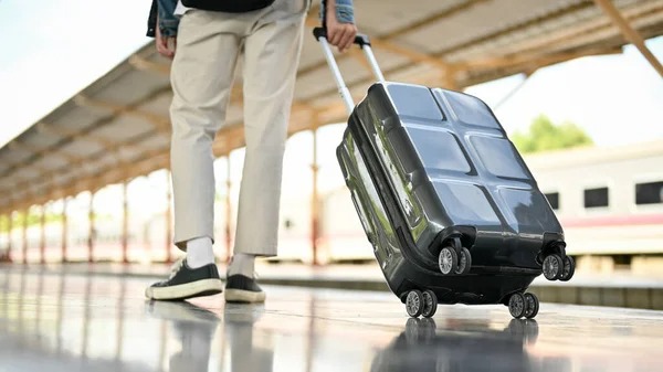 imgi 25 stock photo cropped image male commuter walking platform his suitcase railway station