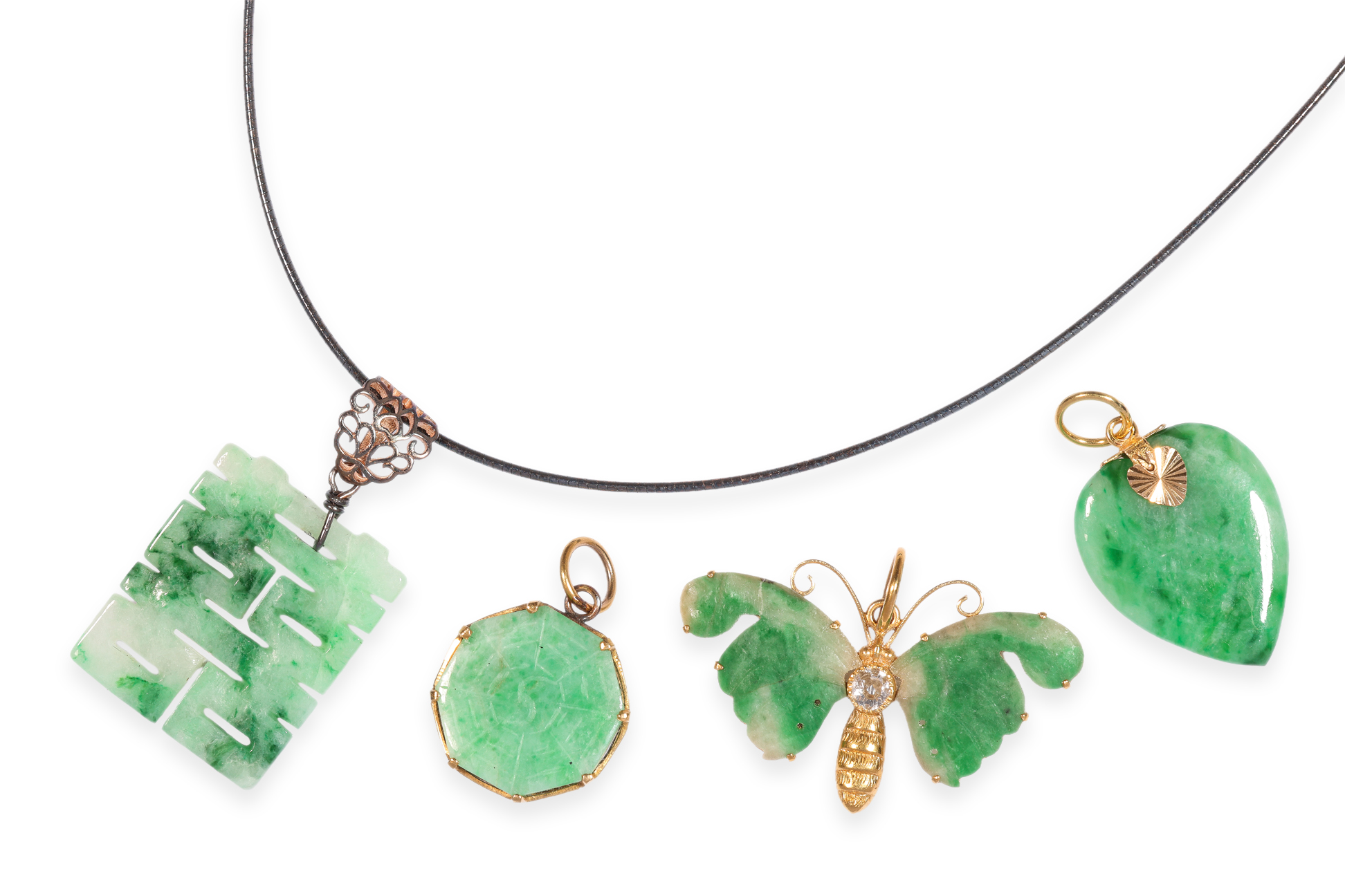 A GROUP OF FOUR JADE PENDANTS