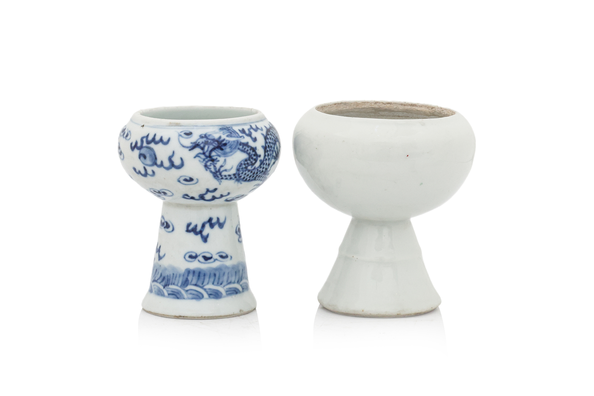 A BLANC-DE-CHINE AND A BLUE AND WHITE PEDESTAL CUP