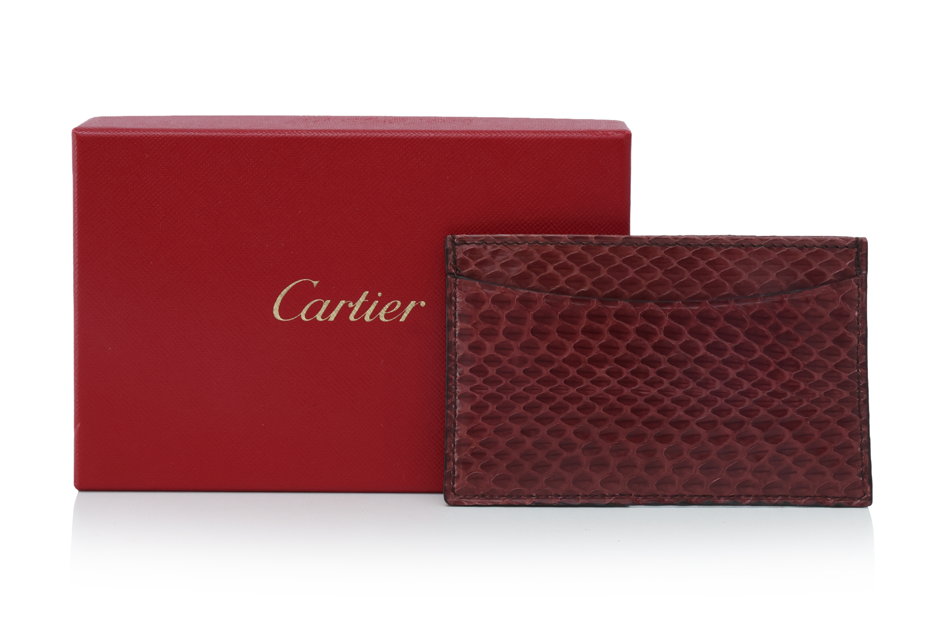 CARTIER - A BURGUNDY PYTHON LEATHER CARD HOLDER