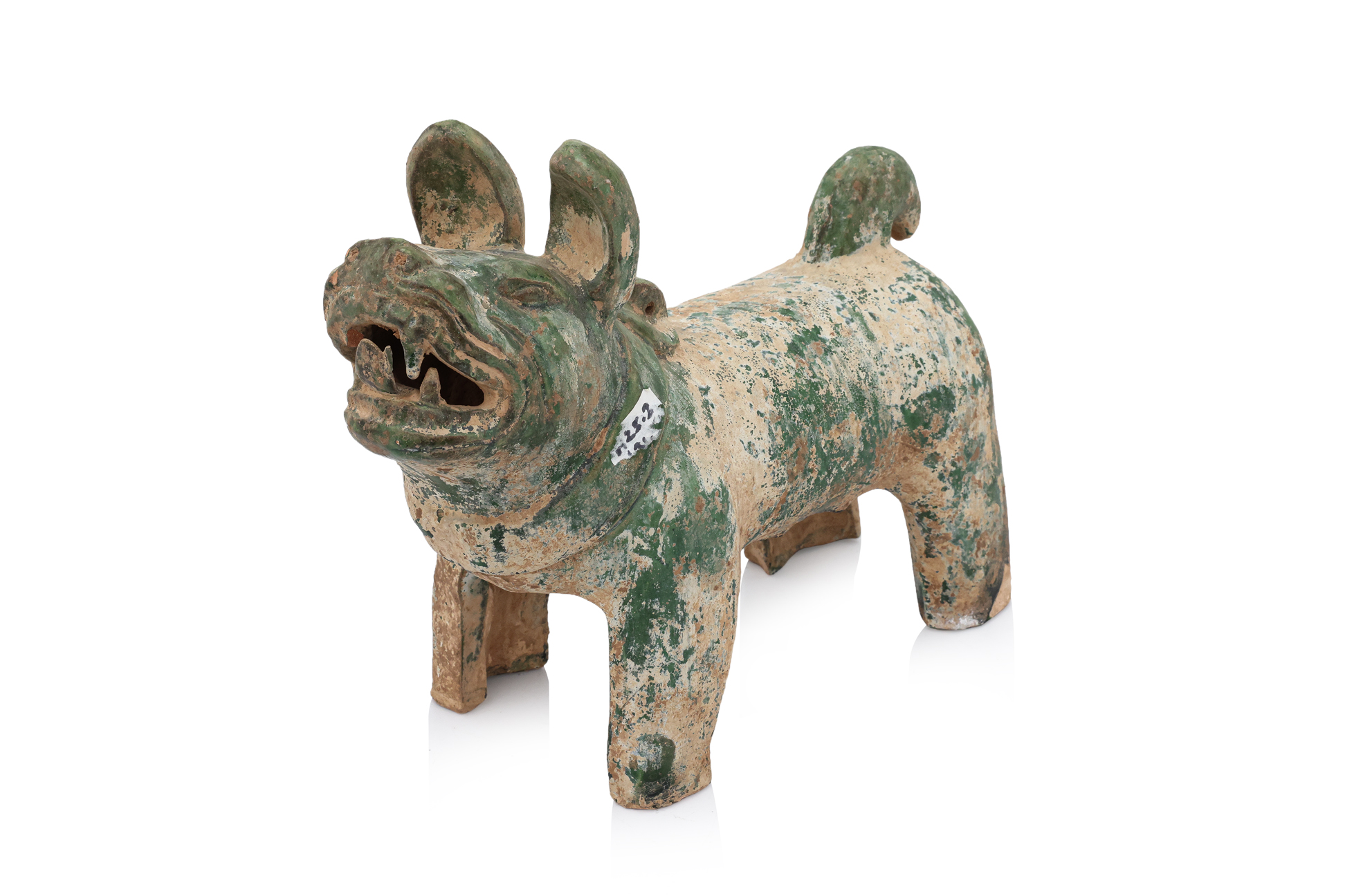 A GREEN-GLAZED EARTHENWARE FIGURE OF A DOG
