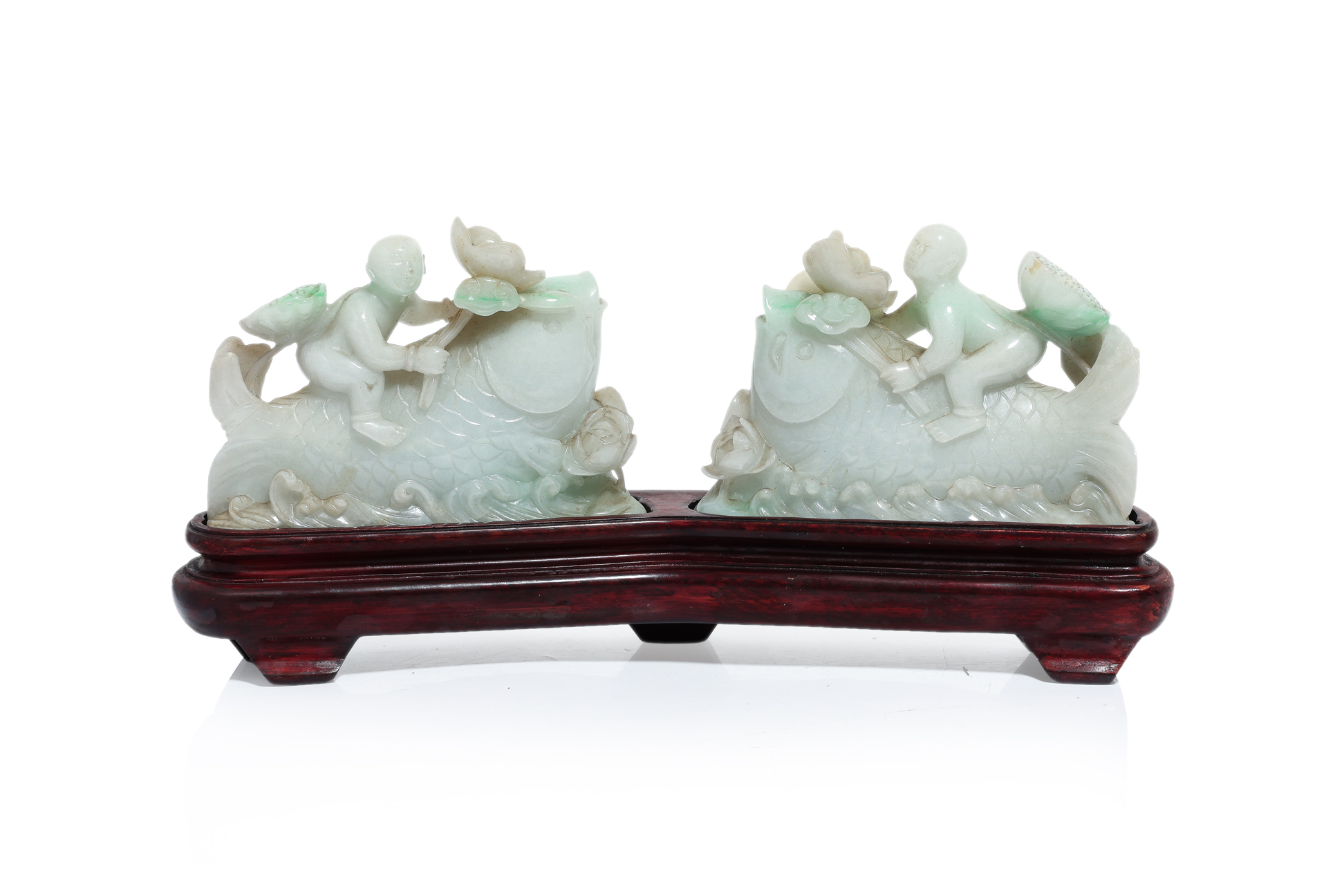 A PAIR OF JADEITE CARVINGS OF A BOY RIDING A FISH