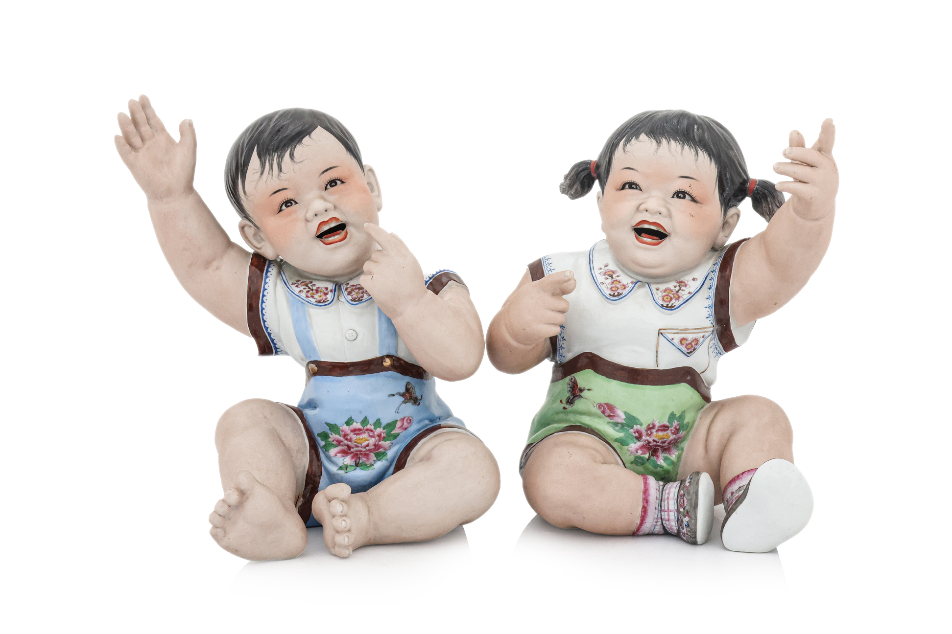 A PAIR OF CULTURAL REVOLUTION PORCELAIN FIGURES OF CHILDREN