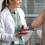 middle aged woman with skin cancer talking with her doctor 23 2148988521 340x570 1