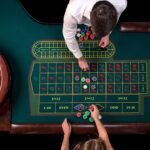 man croupier woman playing roulette table casino top view roulette green table with tape measure 1 1