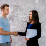 young man woman shaking hands 23 2148252054