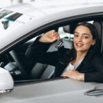 woman sitting inside car holding keys 1