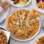 pizza and a doner kebab side by side on a table